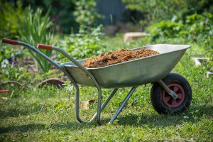 Garden-wheelbarrow,Filled,With,Soil,On,A,Farm